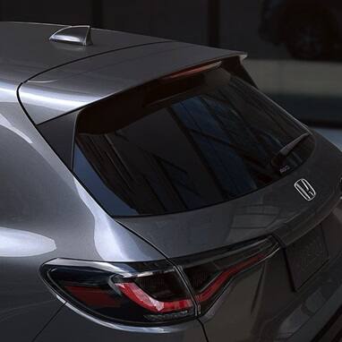 2028 Honda HR-V EX-L in Modern Steel Metallic rear view parked on a city street (Subcompact Crossover SUV).